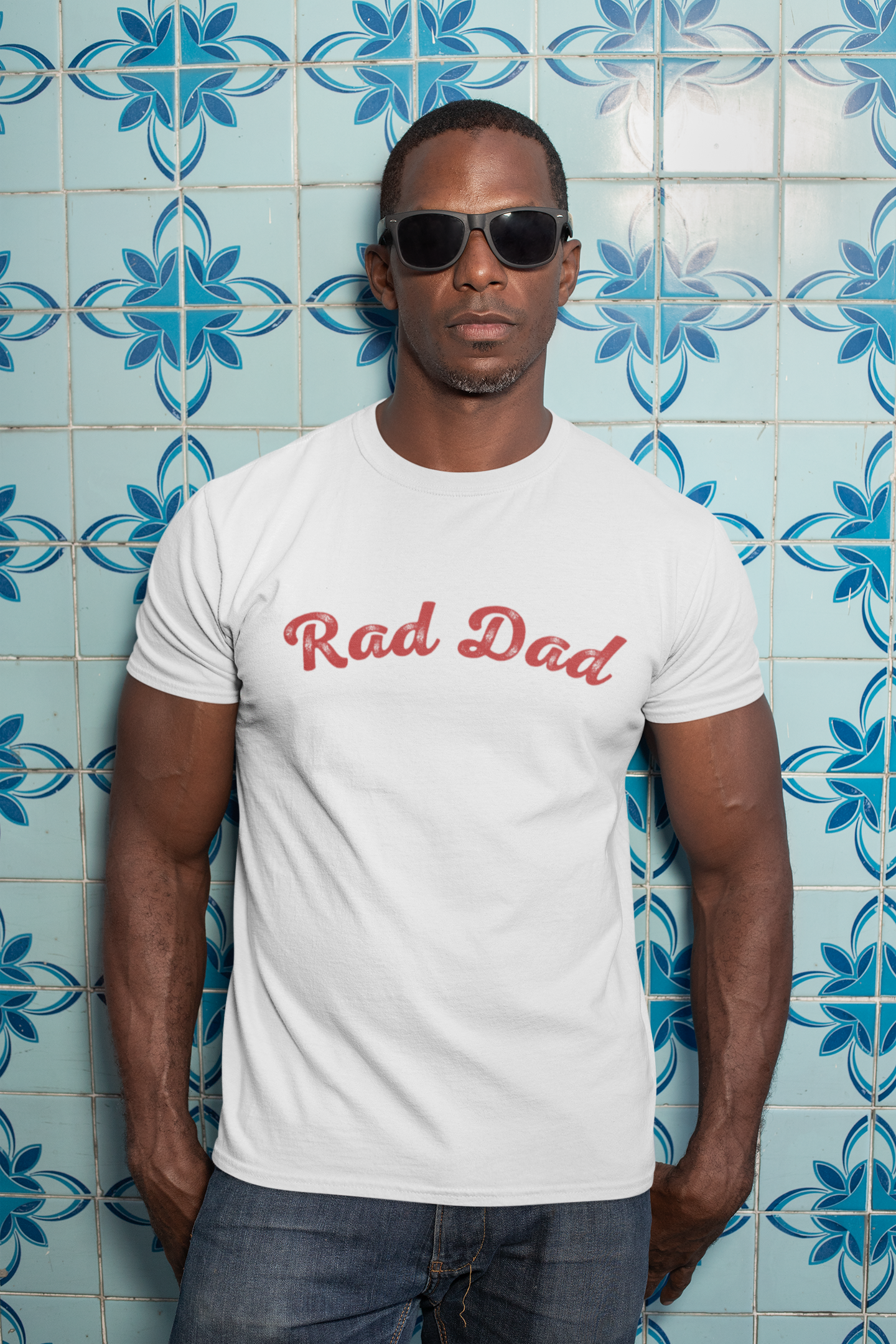 A Man standing ooutside wearing a t shirt with a Red Rad Dad Graphic on the front