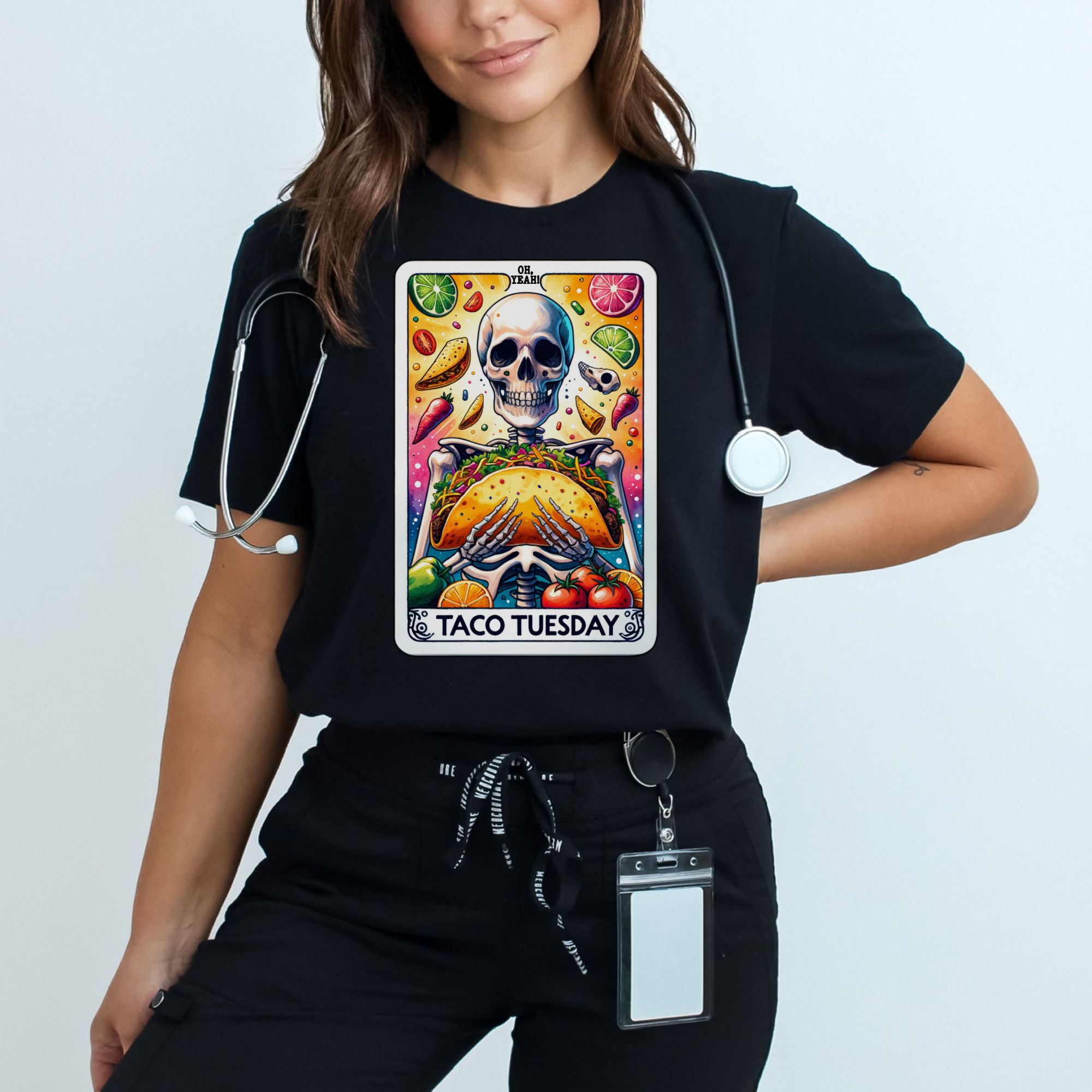 Black t-shirt with a unique 'Taco Tuesday' design featuring a skeleton holding a large taco, surrounded by vibrant ingredients like lime slices, chili peppers, and tomatoes. Perfect for those who enjoy a fun, slightly edgy take on Taco Tuesday.