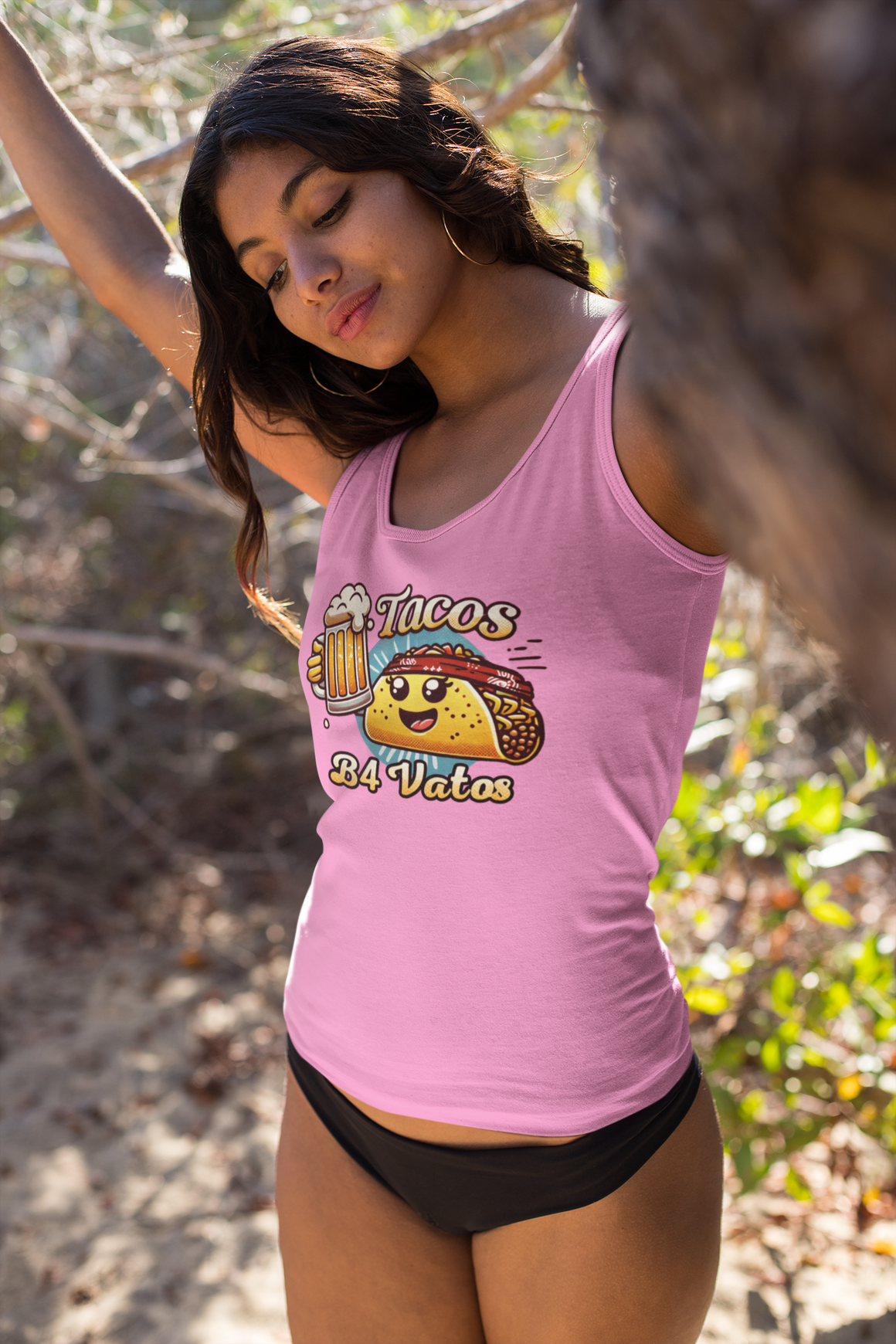 Woman wearing a 'Tacos B4 Vatos' tank top featuring a cheerful taco character with a beer mug, enjoying a lively outdoor celebration. Perfect tank top for taco lovers who want a fun and festive vibe.