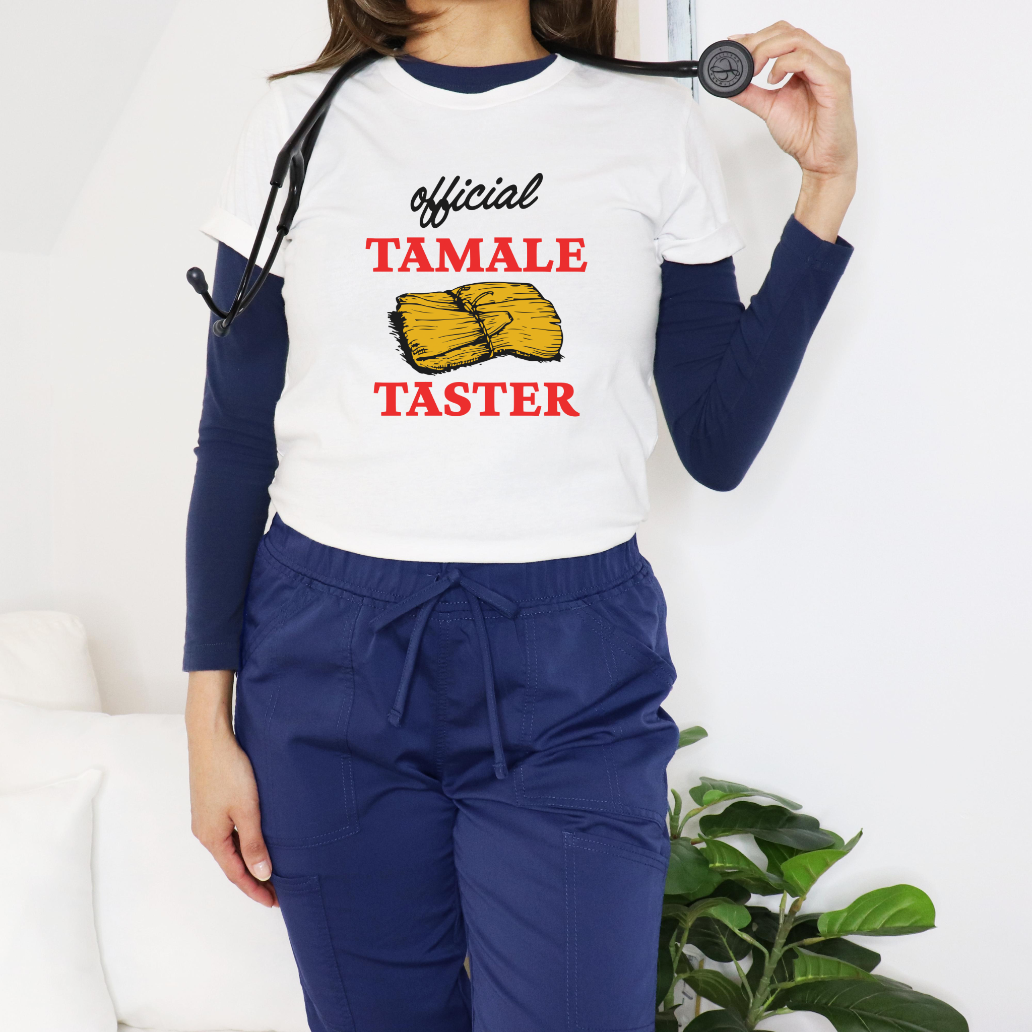 Smiling woman wearing a white T-shirt with bold red text 'Official Tamale Taster' and a tamale graphic, perfect for funny Christmas shirts and holiday gatherings.