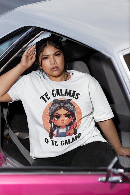 White T-shirt featuring a feisty cartoon character with the Spanish phrase 'Te Calmas o Te Calmo,' adding a humorous and bold statement. Ideal for those with a playful attitude and love for expressive, culturally inspired designs