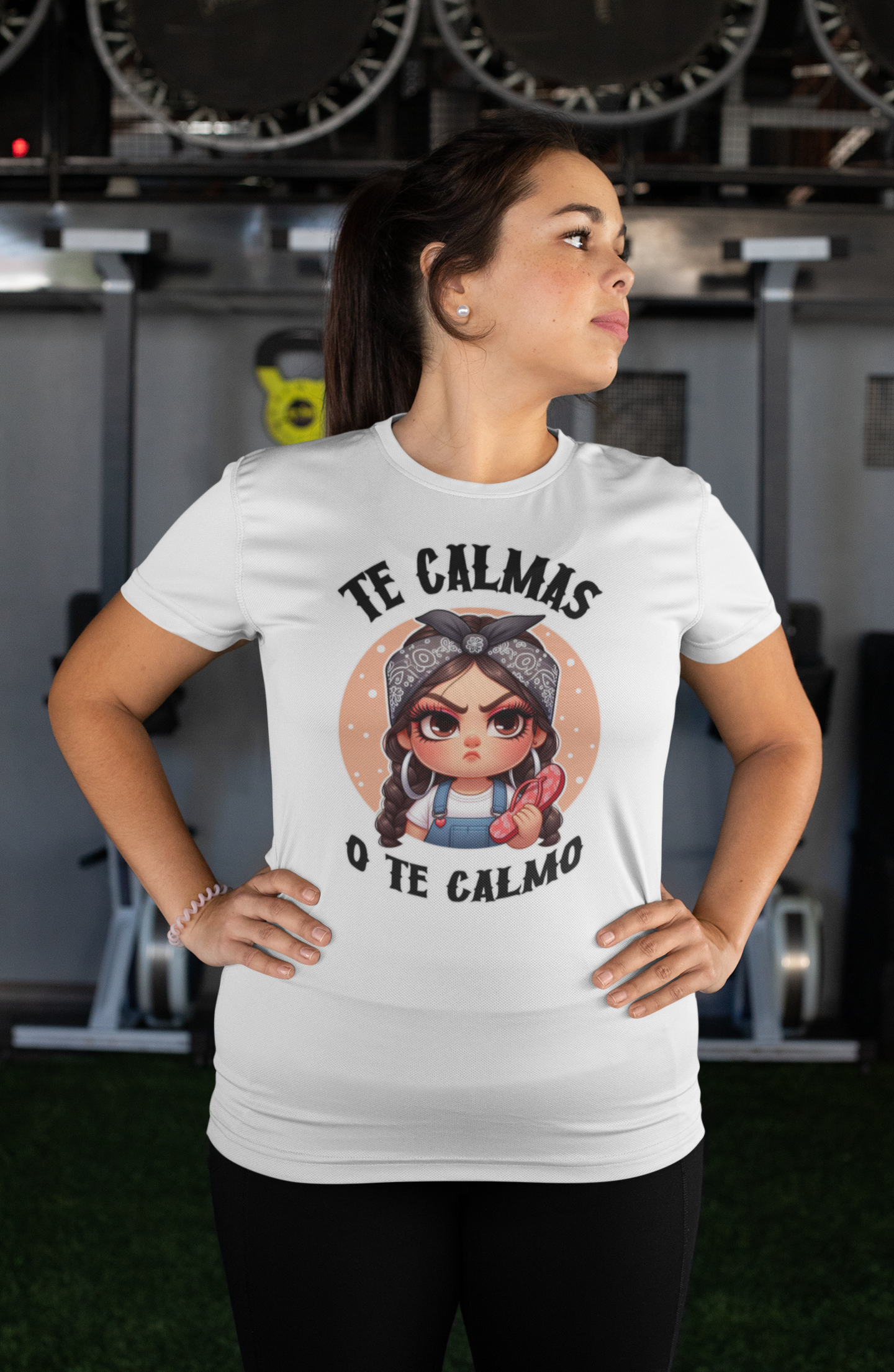 White T-shirt featuring a feisty cartoon character with the Spanish phrase 'Te Calmas o Te Calmo,' adding a humorous and bold statement. Ideal for those with a playful attitude and love for expressive, culturally inspired designs