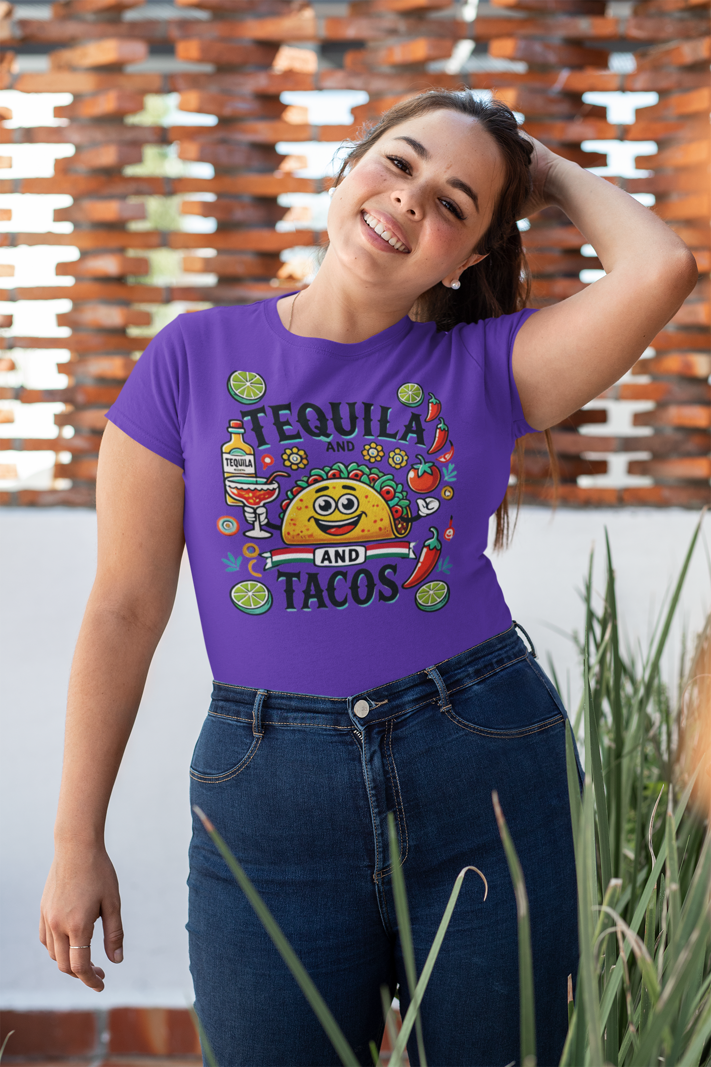 Purple t-shirt featuring a festive 'Tequila and Tacos' design with a smiling taco character, tequila bottle, margarita glass, lime slices, and chili peppers. Perfect for celebrating fiestas and taco nights with a fun and lively style.