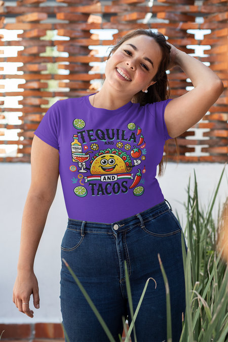 Purple t-shirt featuring a festive 'Tequila and Tacos' design with a smiling taco character, tequila bottle, margarita glass, lime slices, and chili peppers. Perfect for celebrating fiestas and taco nights with a fun and lively style.