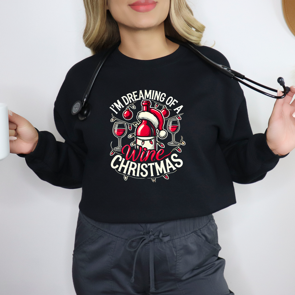 Black Christmas sweatshirt with a festive wine theme, featuring a Santa-capped wine bottle, wine glasses, ornaments, and the humorous text 'I'm Dreaming of a Wine Christmas.' Ideal holiday apparel for wine enthusiasts seeking a fun and stylish Christmas-themed sweatshirt.