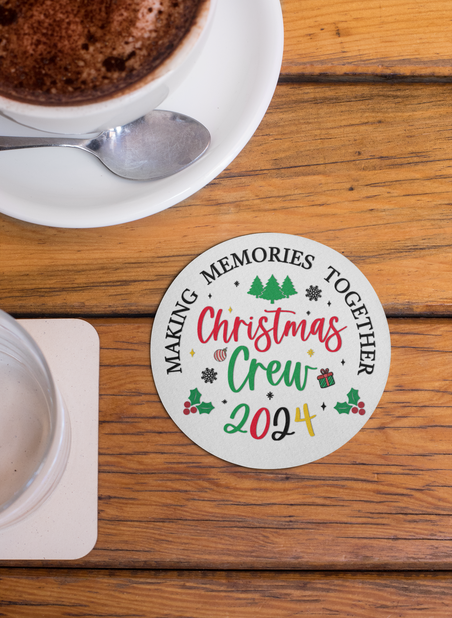 Christmas Crew 2024 ceramic coaster with festive design featuring trees, holly, snowflakes, and gift icons. Text reads 'Making Memories Together,' ideal for holiday gatherings, Christmas parties, and seasonal decor. Perfect for adding a cheerful touch to holiday tables and drinkware.