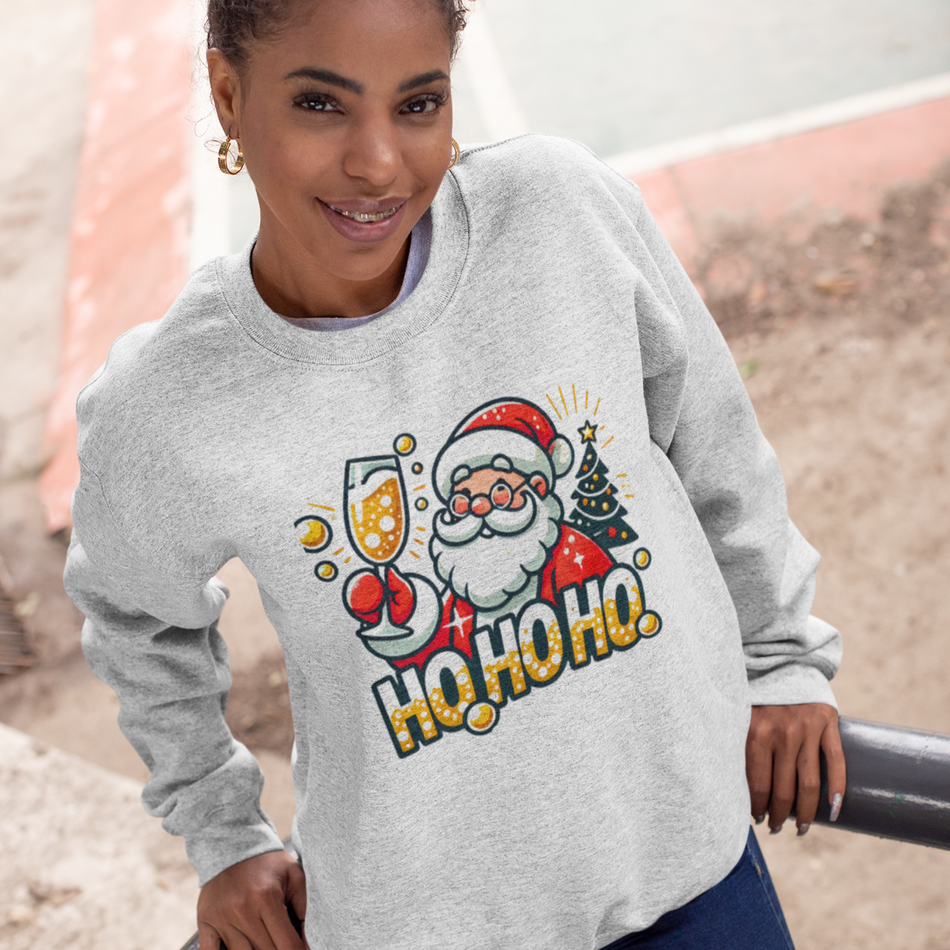 White Christmas sweatshirt featuring a cheerful Santa holding a champagne glass, next to a decorated Christmas tree and the festive text 'Ho Ho Ho.' A fun holiday sweatshirt perfect for adding Christmas cheer to any celebration.