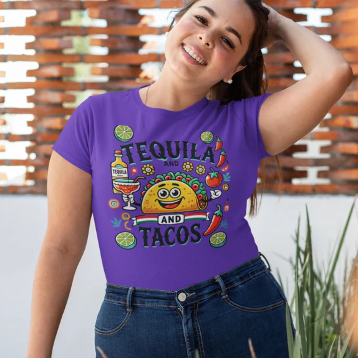 Purple t-shirt featuring a festive 'Tequila and Tacos' design with a smiling taco character, tequila bottle, margarita glass, lime slices, and chili peppers. Perfect for celebrating fiestas and taco nights with a fun and lively style.