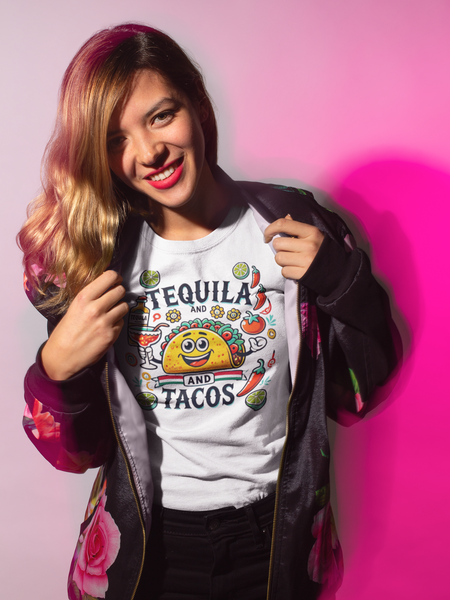 White T-shirt featuring a festive 'Tequila and Tacos' design with a smiling taco character, tequila bottle, margarita glass, lime slices, and chili peppers. Perfect for celebrating fiestas and taco nights with a fun and lively style.